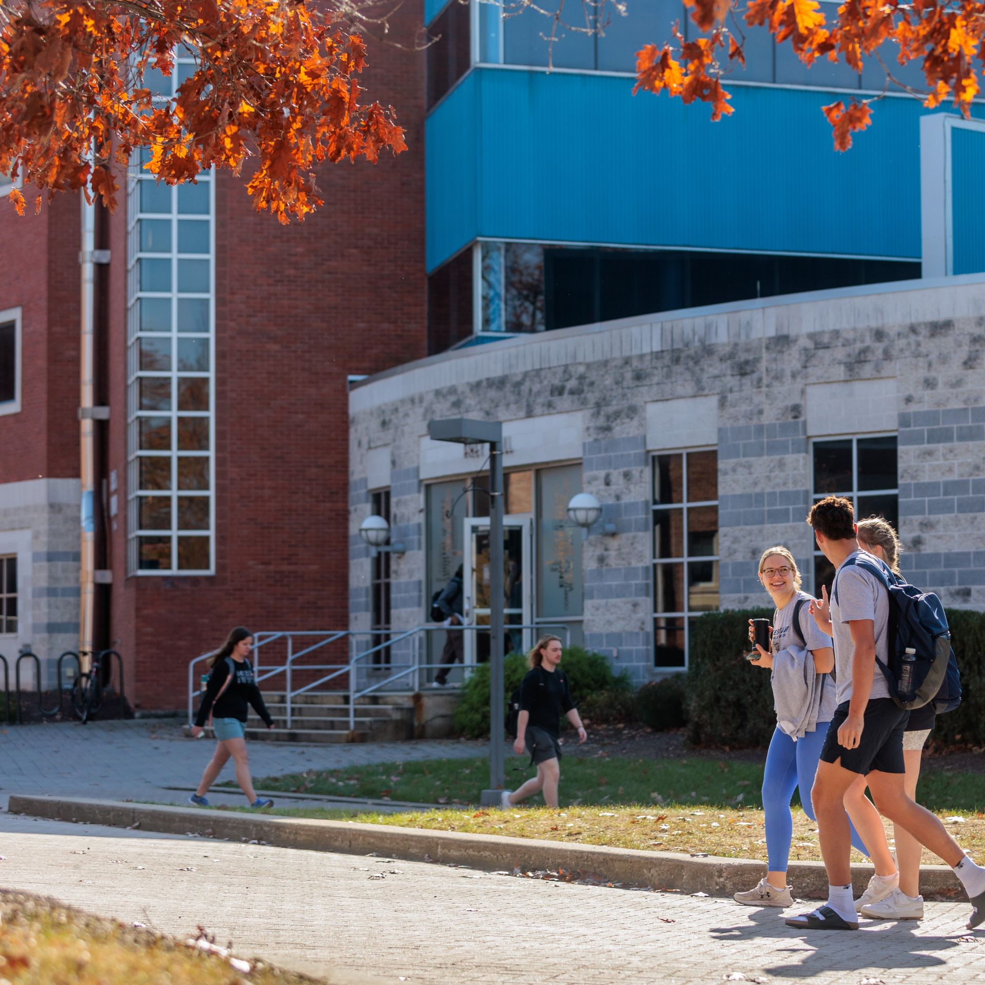 students outside Jordan Science Center walking to classes on an autumn day